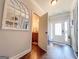 Welcoming foyer with hardwood floors, leading to a half bathroom with granite countertop vanity at 125 Kayla Ct, Locust Grove, GA 30248