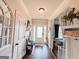 Inviting foyer with hardwood floors, decorative mirror, and white front door with decorative glass panel at 125 Kayla Ct, Locust Grove, GA 30248