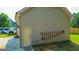 Attached garage with siding, exterior door, and a ladder hanging on the side at 125 Kayla Ct, Locust Grove, GA 30248