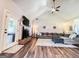 Inviting living room featuring a brick fireplace, ample seating, and wood floors, perfect for relaxation and entertainment at 125 Kayla Ct, Locust Grove, GA 30248