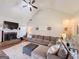 Cozy living room featuring a brick fireplace, large sectional, and vaulted ceilings, perfect for Gathering gatherings at 125 Kayla Ct, Locust Grove, GA 30248