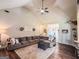 Open-concept living room with a fireplace, vaulted ceiling, and cozy sectional, ideal for entertaining and Gathering time at 125 Kayla Ct, Locust Grove, GA 30248
