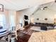 Open concept living room with fireplace, dining area, and view to the kitchen at 125 Kayla Ct, Locust Grove, GA 30248