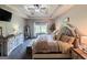 Relaxing main bedroom with tray ceiling, ceiling fan, and a king-size bed filled with pillows at 125 Kayla Ct, Locust Grove, GA 30248