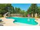 Backyard inground pool with a slide, diving board, and expansive concrete patio at 125 Kayla Ct, Locust Grove, GA 30248