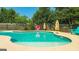 Beautiful in-ground pool features steps for easy entry and a tanning ledge for relaxing in the sun at 125 Kayla Ct, Locust Grove, GA 30248