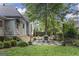 Backyard featuring a stone patio with outdoor seating and landscaped garden at 3119 Conyers Se St, Covington, GA 30014