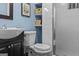 A bathroom featuring a vanity, toilet, shower, and decorative shelving at 3119 Conyers Se St, Covington, GA 30014