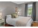 A serene bedroom with hardwood floors, a large window and stylish neutral-toned decor at 3119 Conyers Se St, Covington, GA 30014