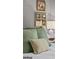 The bedroom has a bed with olive green and beige pillows and wall art at 3119 Conyers Se St, Covington, GA 30014