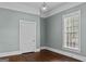 Bright bedroom features hardwood floors, light blue walls, and window for lots of natural light at 3119 Conyers Se St, Covington, GA 30014