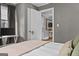 A bedroom with light gray walls and a beige comforter and pillows on the bed at 3119 Conyers Se St, Covington, GA 30014