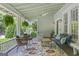 Inviting covered porch with comfortable seating and a ceiling fan for year-round enjoyment at 3119 Conyers Se St, Covington, GA 30014