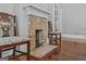 Stylish dining room features a vintage brick fireplace and beautiful refinished hardwood floors at 3119 Conyers Se St, Covington, GA 30014