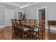 Formal dining room featuring an elegant dining table and refinished hardwood floors at 3119 Conyers Se St, Covington, GA 30014