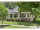 Charming home boasts a large, inviting wraparound porch with swing and landscaped yard at 3119 Conyers Se St, Covington, GA 30014