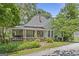 Charming home with light-green siding, landscaped front yard, and covered front porch at 3119 Conyers Se St, Covington, GA 30014
