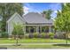 Charming home with light-green siding, landscaped front yard, and covered front porch at 3119 Conyers Se St, Covington, GA 30014