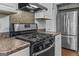 Bright kitchen features stainless steel appliances and stone countertops at 3119 Conyers Se St, Covington, GA 30014
