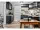 A cozy kitchen features dark cabinets, light wood floors, and a dining table with green chairs at 3119 Conyers Se St, Covington, GA 30014