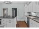 Bright kitchen features an island with black countertops and stainless steel appliances, cabinets, and a sink at 3119 Conyers Se St, Covington, GA 30014