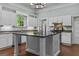Bright kitchen with white cabinets, a large island, and stainless steel appliances at 3119 Conyers Se St, Covington, GA 30014