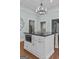 Bright kitchen features an island with black countertops and stainless steel microwave at 3119 Conyers Se St, Covington, GA 30014