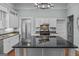 Bright kitchen with white cabinets, a large island, and stainless steel appliances at 3119 Conyers Se St, Covington, GA 30014