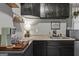 Convenient kitchenette with sleek black cabinets, a mini-fridge, and countertop space at 3119 Conyers Se St, Covington, GA 30014