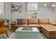 Bright living room with a large sectional sofa, and a cozy rug, perfect for relaxing at 3119 Conyers Se St, Covington, GA 30014