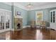 Spacious living room with stone fireplace, beautiful refinished hardwood floors, and French doors at 3119 Conyers Se St, Covington, GA 30014