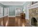 Open living room with refinished hardwood floors, stone fireplace and glass french doors at 3119 Conyers Se St, Covington, GA 30014