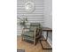 A relaxed living space showcases a green chair, plant and table with a clock above at 3119 Conyers Se St, Covington, GA 30014