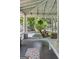 Inviting covered porch features a swing, wood flooring, and string lights at 3119 Conyers Se St, Covington, GA 30014