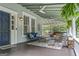 Inviting covered porch with comfortable seating, ceiling fans, and decorative lighting at 3119 Conyers Se St, Covington, GA 30014