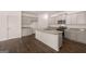 Modern kitchen features gray cabinets, granite countertops, stainless steel appliances and a center island at 11884 Aukerman Way, Hampton, GA 30228