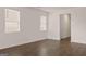 Bright living room with wood floors and white walls and large windows with horizontal blinds at 11884 Aukerman Way, Hampton, GA 30228