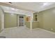 A view of the basement with white tiled floors, and olive green walls, with access to storage and a built-in bar at 305 Sherwood Rd, Fayetteville, GA 30215