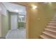 Basement entryway with tiled floors leading to a carpeted staircase at 305 Sherwood Rd, Fayetteville, GA 30215