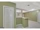Basement view of the tiled floor, a wet bar, and built-in shelving with closed and open storage options at 305 Sherwood Rd, Fayetteville, GA 30215