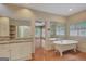 Bright bathroom featuring a classic clawfoot tub, double vanities, and wood floors at 305 Sherwood Rd, Fayetteville, GA 30215
