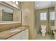 Bathroom with granite countertop vanity, framed mirror, and a shower-tub combination behind a curtain at 305 Sherwood Rd, Fayetteville, GA 30215