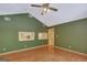Bedroom with hardwood floors, ceiling fan, two windows with view of the yard, and built-in shelving at 305 Sherwood Rd, Fayetteville, GA 30215