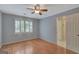 Bedroom with hardwood floors, natural light, and neutral paint, enhancing spacious feel at 305 Sherwood Rd, Fayetteville, GA 30215