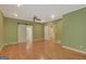 Spacious bedroom with hardwood floors, a ceiling fan, and an ensuite bathroom at 305 Sherwood Rd, Fayetteville, GA 30215