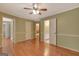 Spacious bedroom with hardwood floors, multiple doorways, and warm neutral paint at 305 Sherwood Rd, Fayetteville, GA 30215