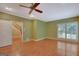 Generous bedroom featuring hardwood floors, ceiling fan, and stairway access at 305 Sherwood Rd, Fayetteville, GA 30215