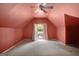 Bedroom with neutral carpet, sloped ceiling, and balcony access through double doors at 305 Sherwood Rd, Fayetteville, GA 30215