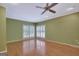 Bright bedroom with hardwood floors, ceiling fan, and bright natural light at 305 Sherwood Rd, Fayetteville, GA 30215