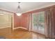 Stylish dining room featuring hardwood floors, shutters, and a modern lighting fixture at 305 Sherwood Rd, Fayetteville, GA 30215